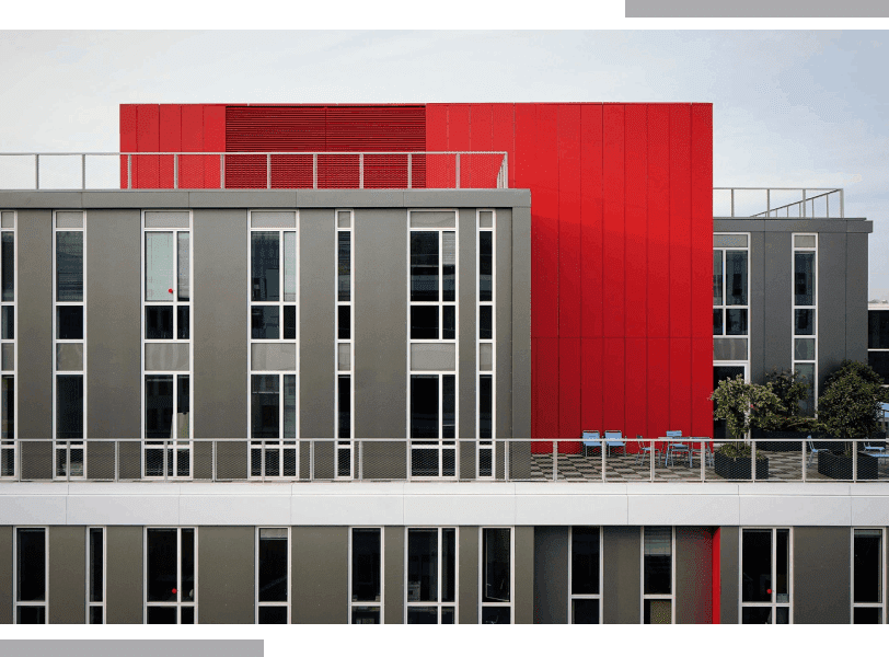 A red building with many windows and balconies.